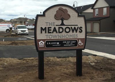 outdoor signs for The Meadows Townhomes