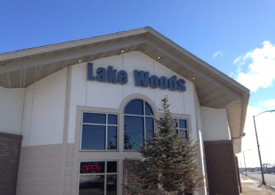 lighted sign on the building for Lake Woods