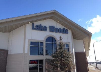 lighted sign on the building for Lake Woods
