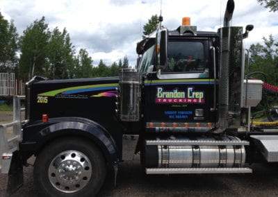 vinyl sign for semi truck Sign is brightly colored and says Brandon Crep Trucking and lists license numbers